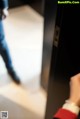 A blurry image of a person standing in an elevator.