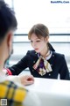 A woman sitting at a table talking to a man.