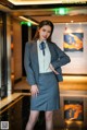 A woman in a business suit posing for a picture.