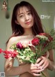 A woman holding a bunch of flowers in her hands.