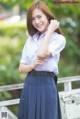 A woman in a school uniform posing for a picture.