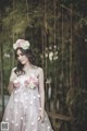 A woman in a pink dress with flowers in her hair.