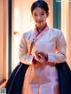 A woman in a hanbok poses for a picture.