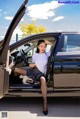 A woman sitting in the driver's seat of a car.