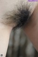 A close up of a woman's hairy armpit.