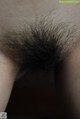 A close up of a woman's hairy ass. 