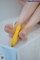 A woman is holding a banana in her hands.